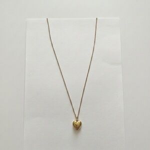 Gold tone necklace with heart shaped charm